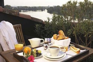 Enjoy a leisurely breakfast on your balcony with a scenic view of the river and surrounding greenery.