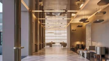 Enter a spacious, well-lit area with a reception desk and comfortable seating.