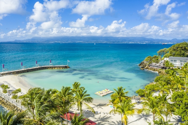 On the beach, white sand, sun-loungers, beach umbrellas