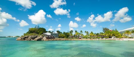 On the beach, white sand, sun loungers, beach umbrellas