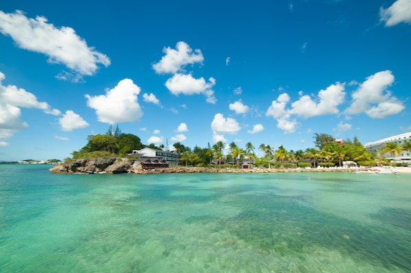 On the beach, white sand, sun loungers, beach umbrellas