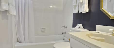 A modern bathroom with a bathtub, toilet, and sink.