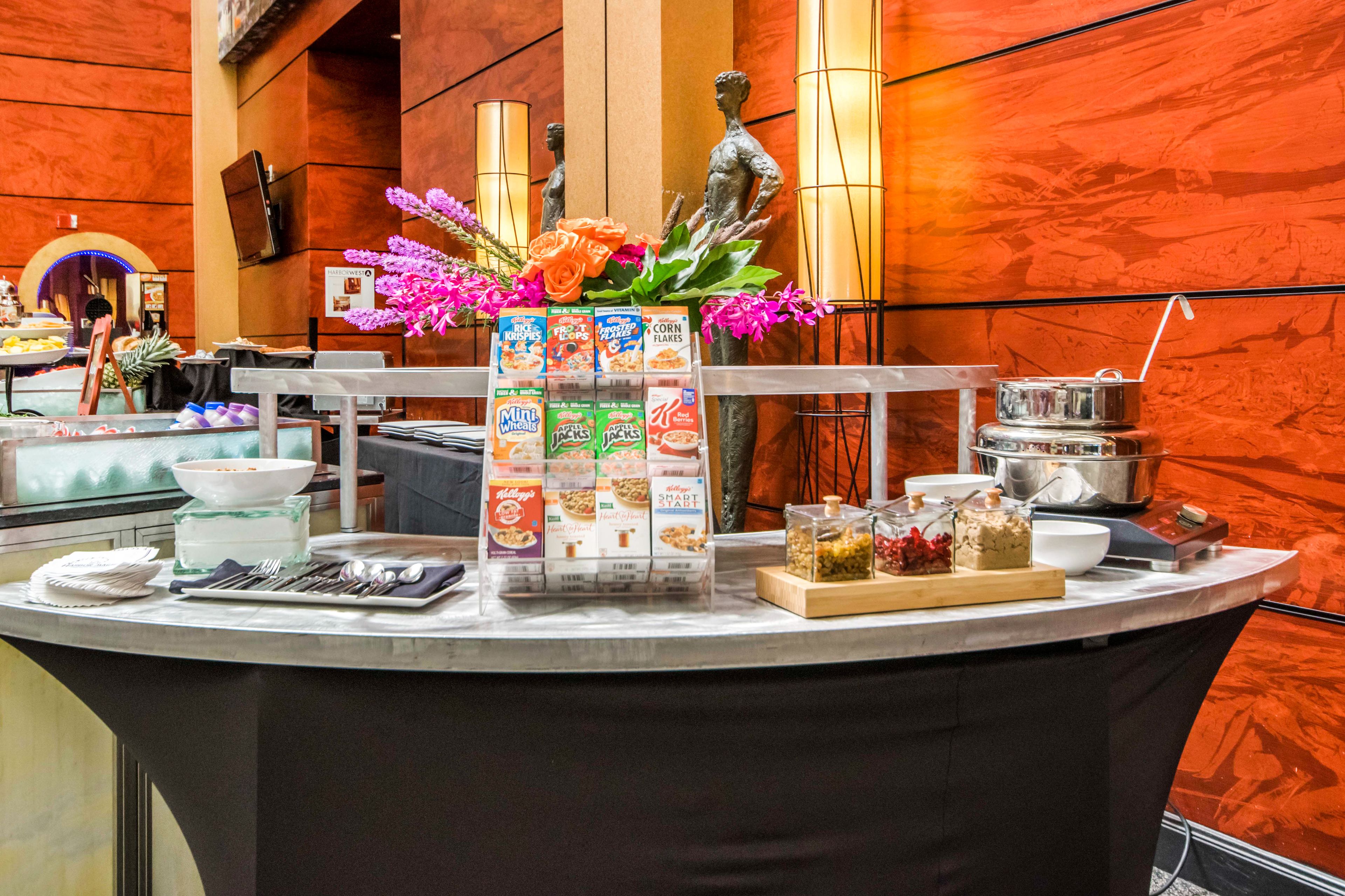 A buffet setup with various food items and a decorative centerpiece.