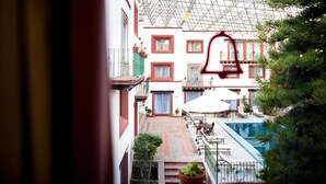 Une cour avec une piscine, un espace salon extérieur et une serre.