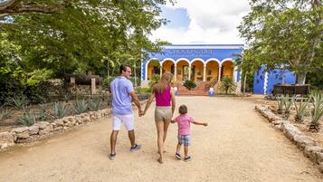 Explore the entrance to Choco-Story Ecoparque del Chocolate, a unique destination surrounded by lush greenery and vibrant architecture.