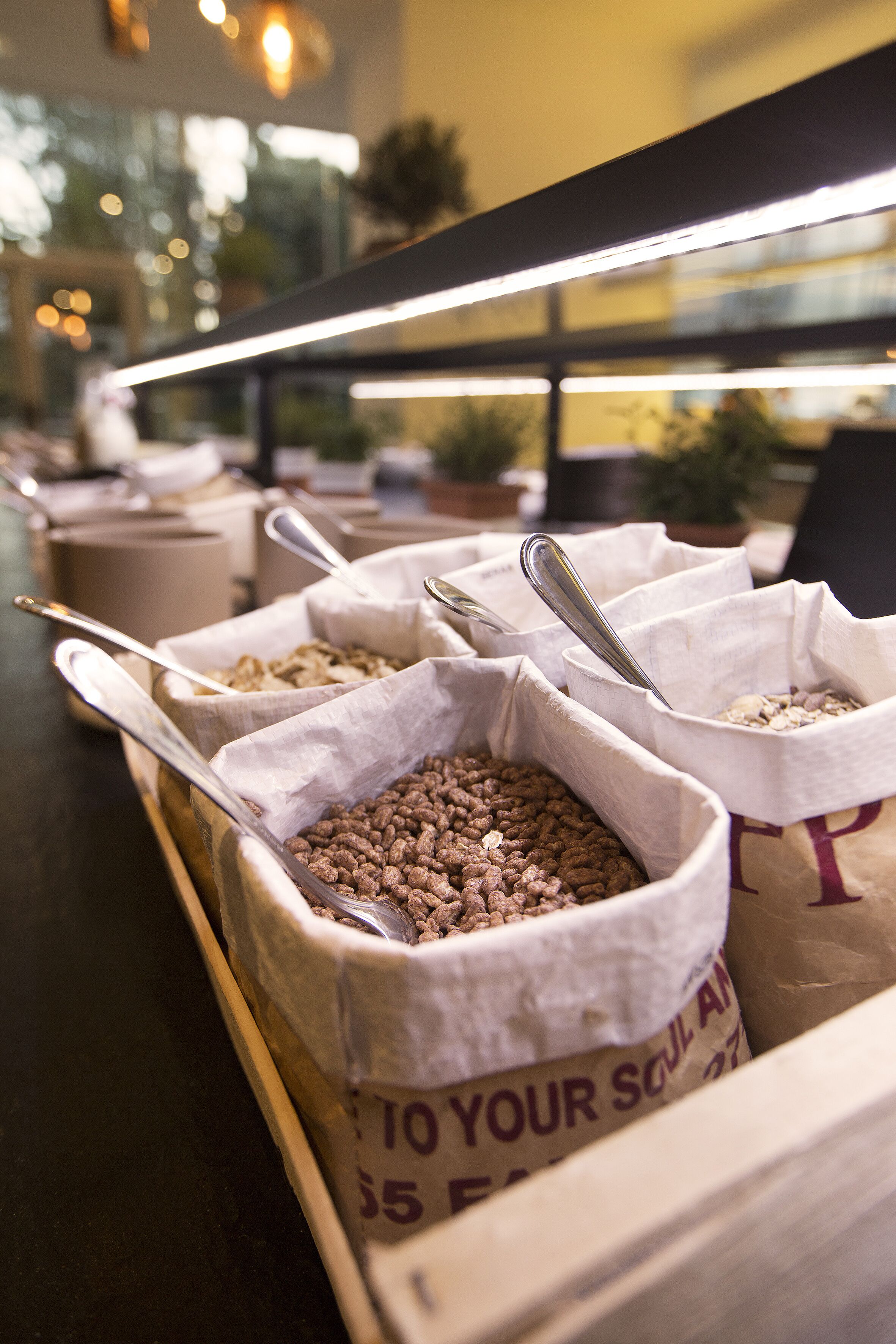A buffet with labeled containers of food items.