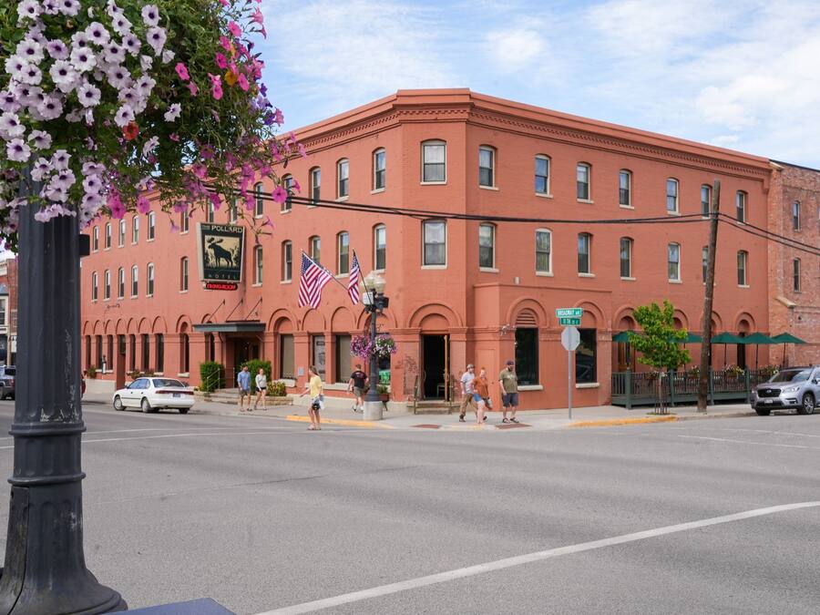 A red brick building with multiple windows and a sign for 'The Pollard Hotel'.