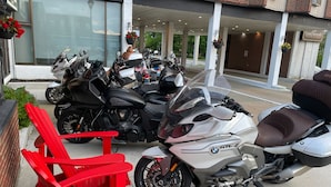 A motorcycle parked in front of a building with a sign that reads "Grand Yarmouth".