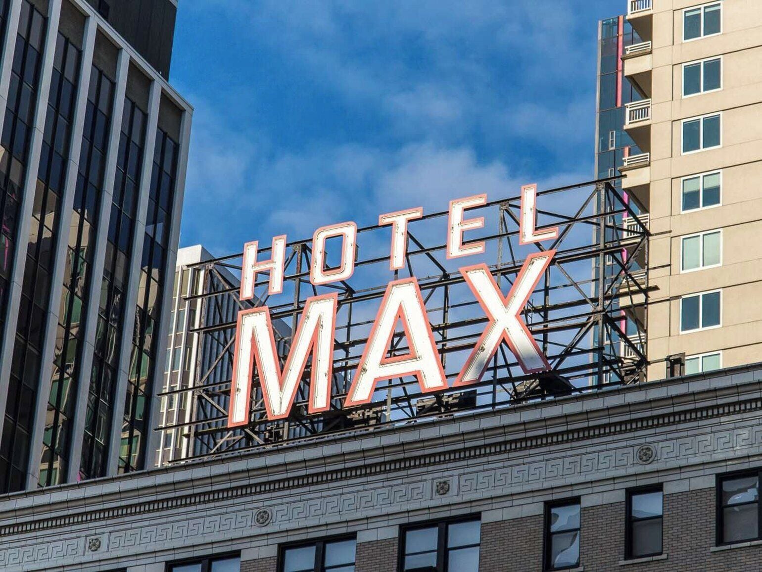 A hotel sign with the name 'HOTEL MAX' in large, illuminated letters.