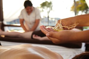 A massage therapy session with a person receiving a treatment.