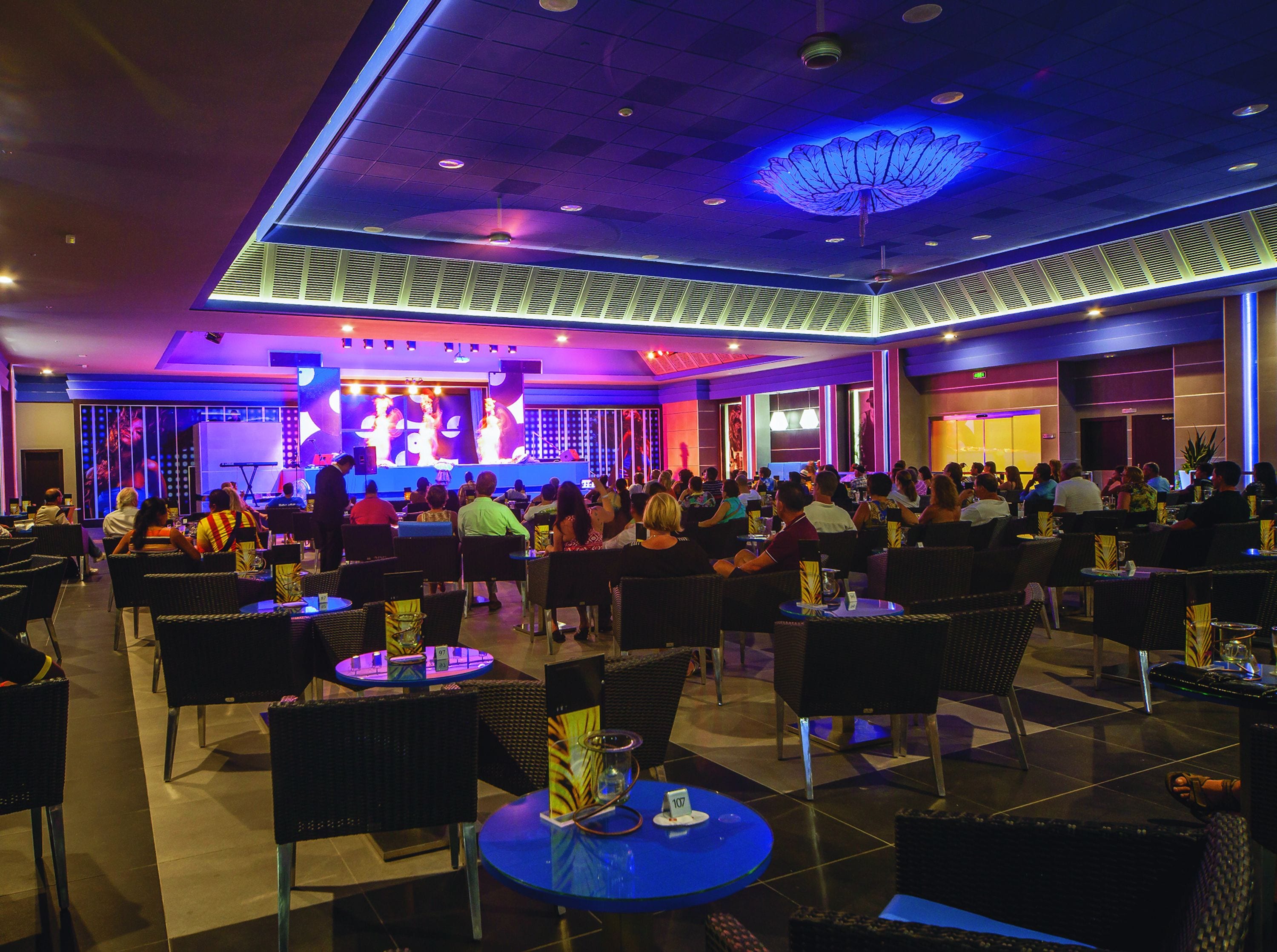 A spacious indoor venue with multiple tables and chairs arranged for dining or socializing.