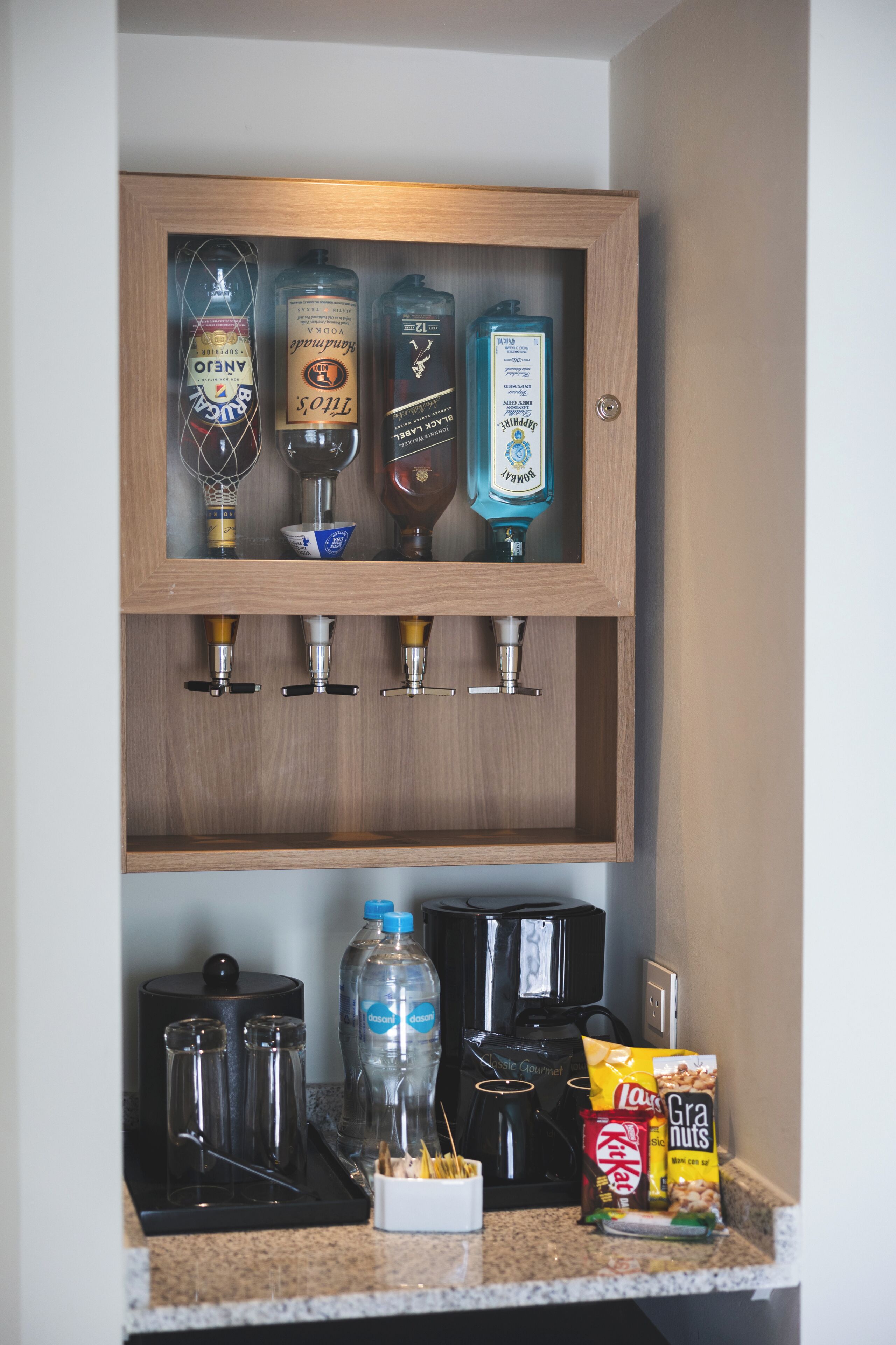 A bar area with liquor bottles and a coffee machine.