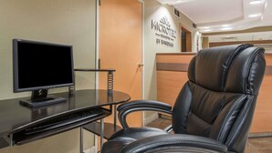 A hotel room with a desk, a computer, and a leather chair. - Microtel Inn & Suites by Wyndham West Chester (West Chester)