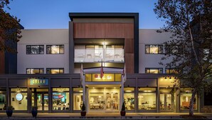 A modern hotel with a two-story structure, large glass windows, and a prominent sign for the Garden Inn. - Hilton Garden Inn Davis Downtown (Davis)