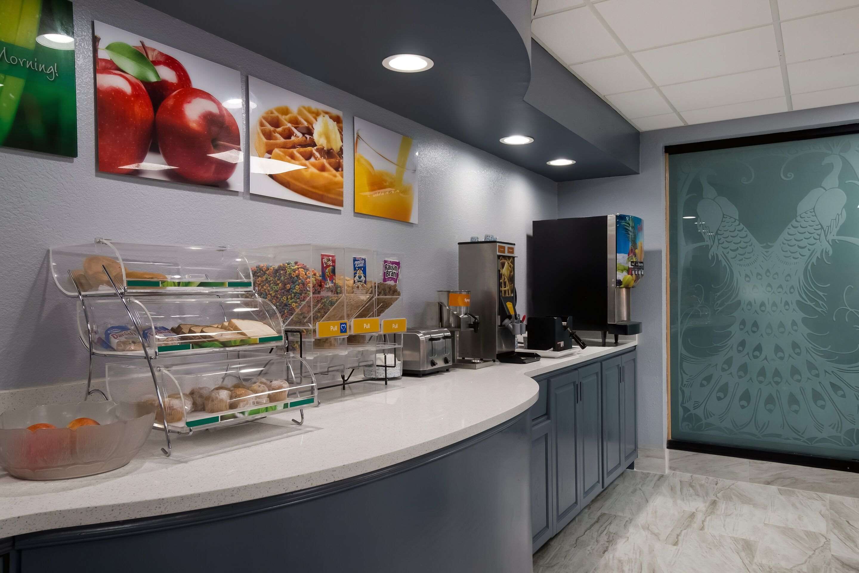 A breakfast counter with a variety of food items and a coffee machine.