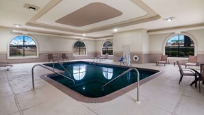 An indoor swimming pool with clear views through arched windows, surrounded by lounge chairs and a tiled floor. - Quality Inn Columbia I-65 (Columbia)