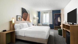 A hotel room with a bed, bedside tables, a TV, a wardrobe, and a window with curtains. - Spark by Hilton Tempe Phoenix Airport (Tempe)
