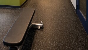 A gym with exercise equipment, a bench, and a motivational quote on the wall. - Spark by Hilton Tempe Phoenix Airport (Tempe)