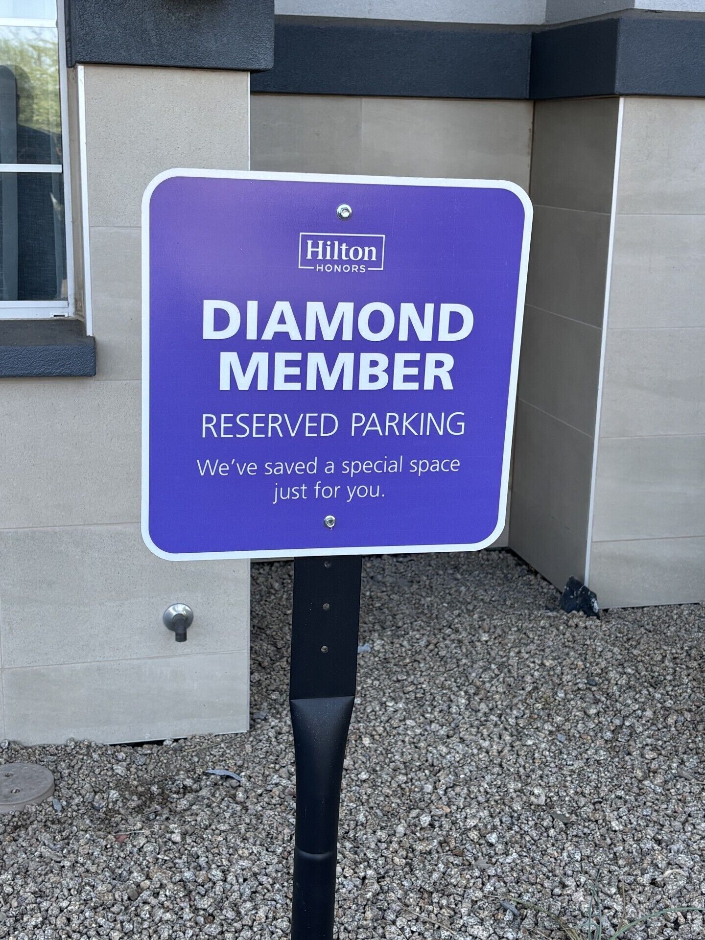 A sign indicating reserved parking for Hilton Honors Diamond Members.