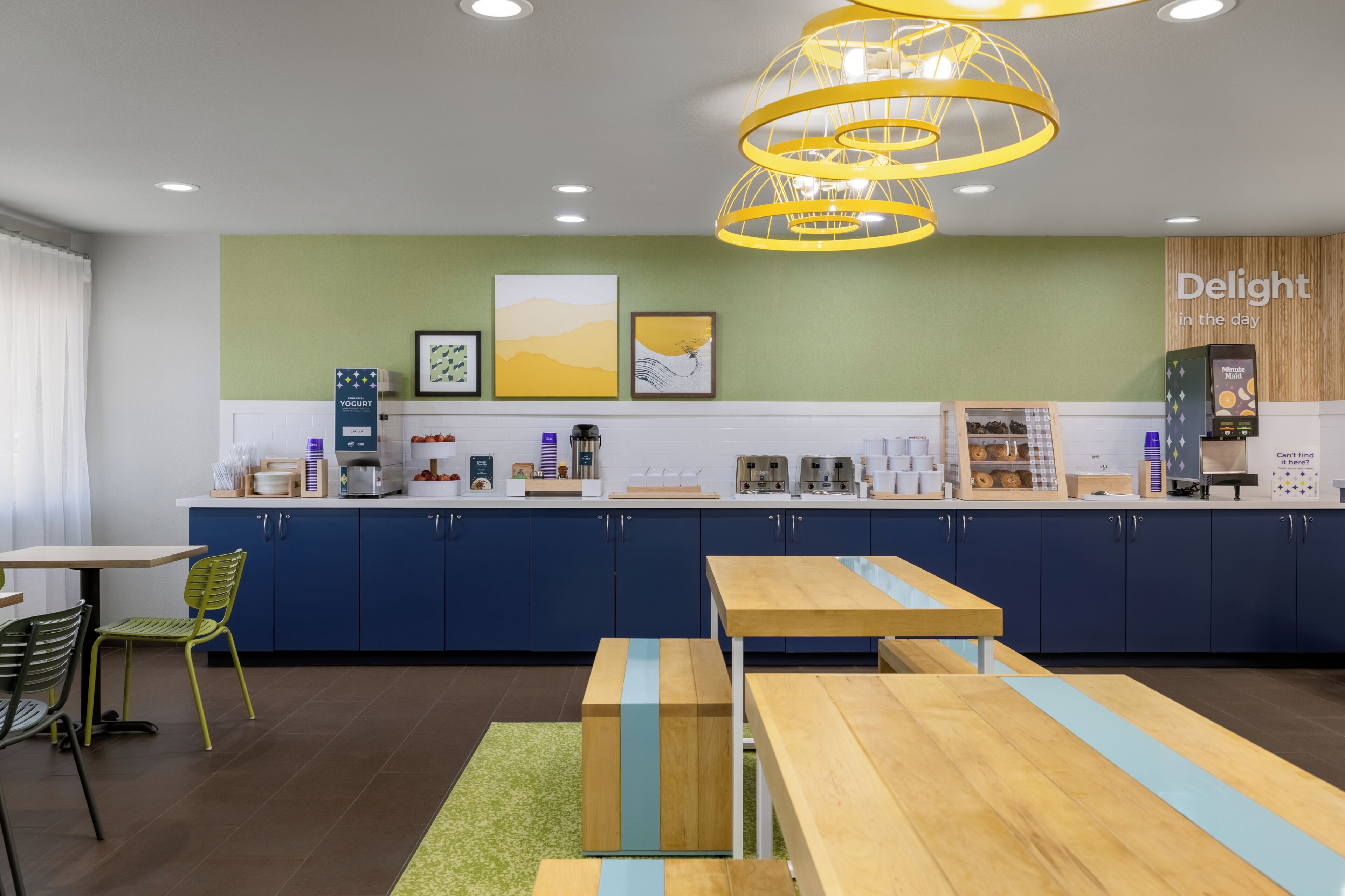 Un área de cocina moderna con cafetera, dispensador de yogur y estación de café.