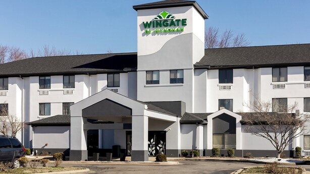 A Wingate by Wyndham hotel with a modern design, featuring a prominent logo on the building.