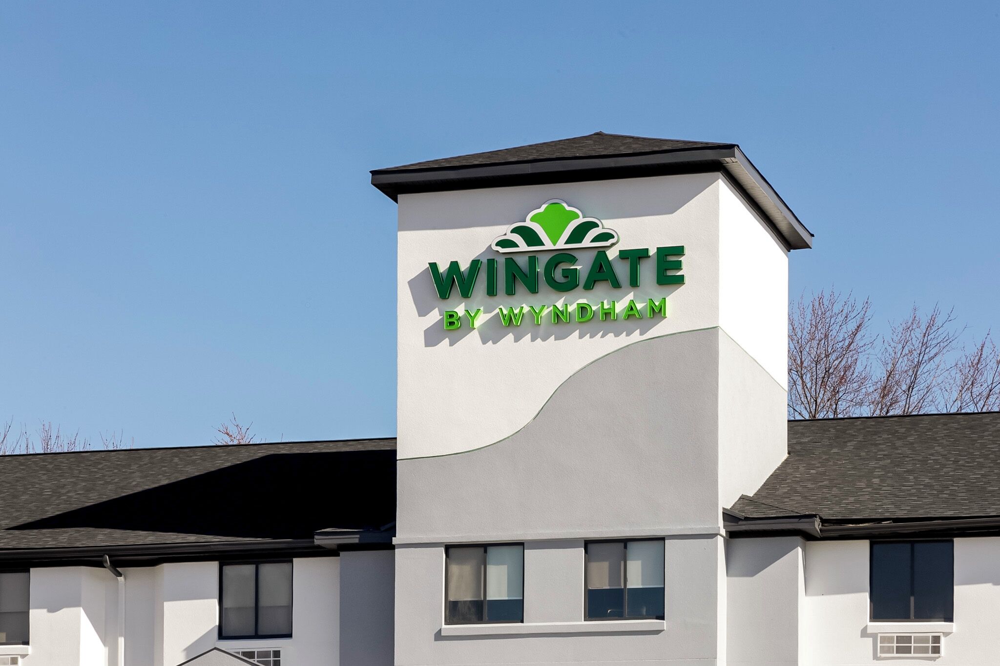 A building with a sign that reads "Wingate by Wyndham."