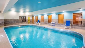 An indoor swimming pool with clear blue water, surrounded by lounge chairs and a blue ceiling. - Wingate by Wyndham Owensboro (Owensboro)