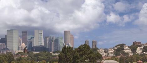 A city skyline with modern buildings and a beach area in the foreground.