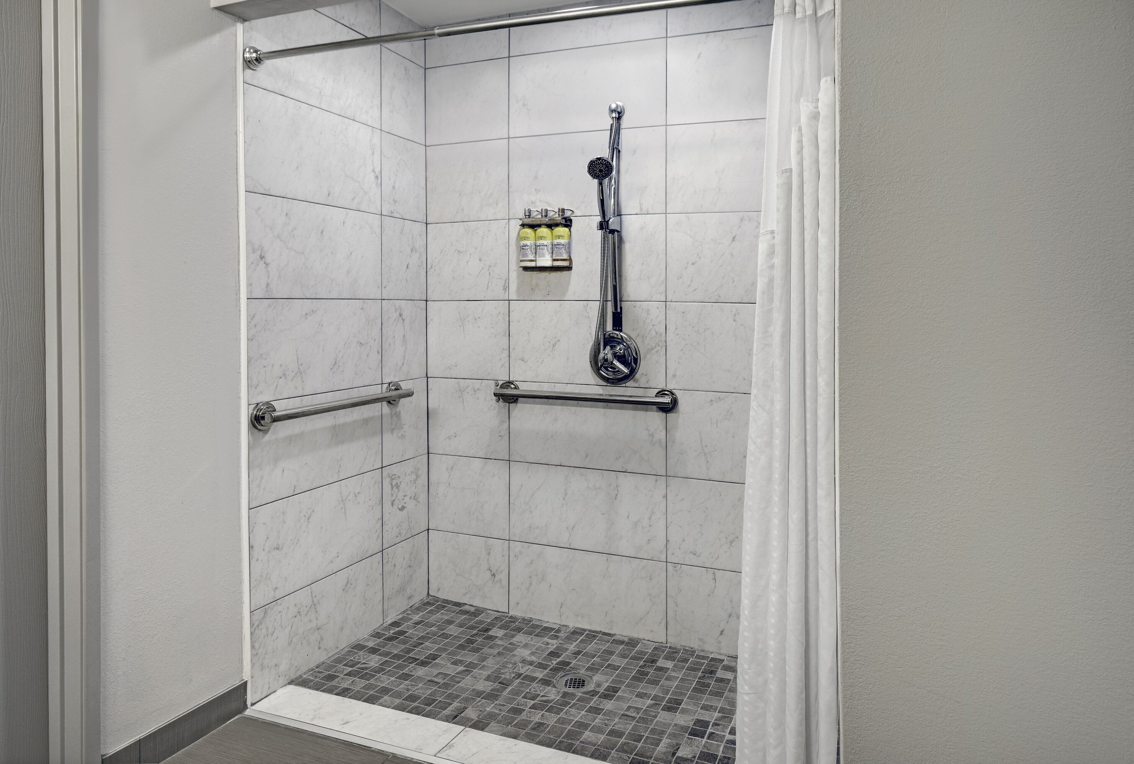 suite, 1 king bed, accessible (communication, roll-in shower) | bathroom | combined shower/bathtub, designer toiletries, hair dryer, towels