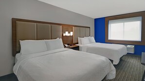 A hotel room with two beds, a nightstand with a phone, a lamp, and a window with blinds. - Holiday Inn Express Adrian by IHG (Adrian)