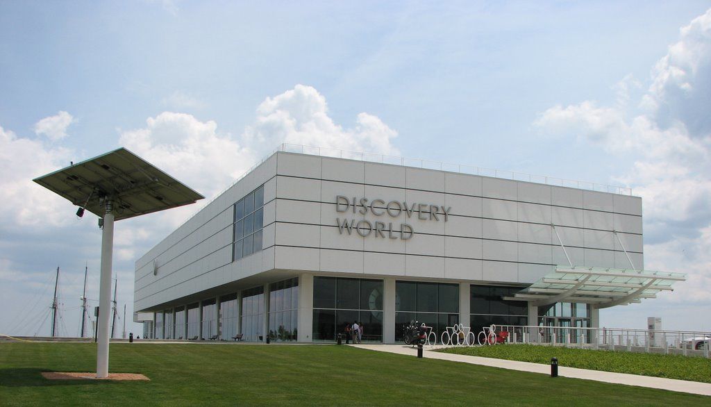 A modern building with the sign "Discovery World" on the facade.