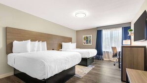 A hotel room with two beds, a desk, a chair, and a large window with curtains. - Best Western Plus Lewisville Flower Mound (Lewisville)