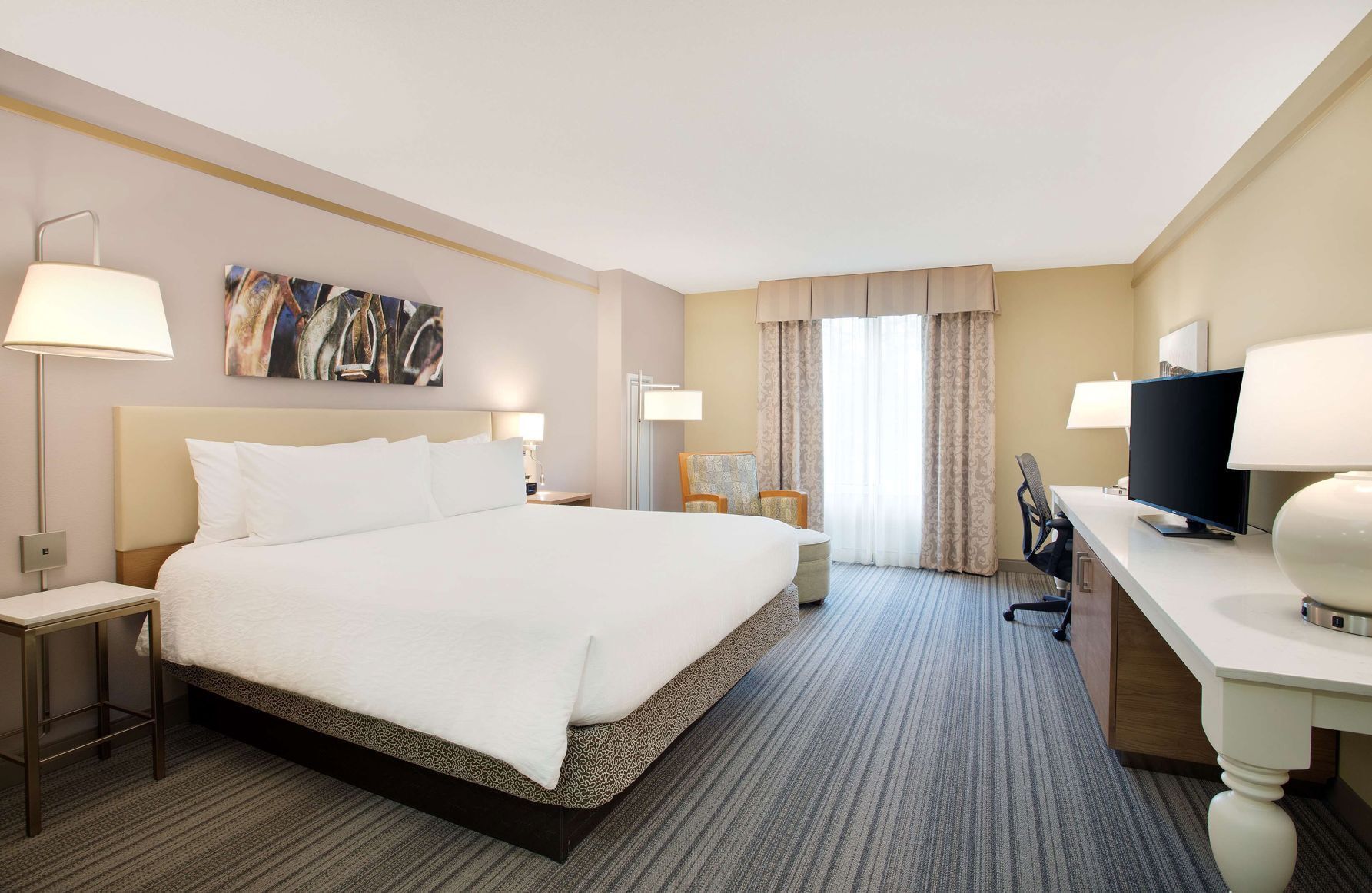 Premium bedding, desk, laptop workspace, blackout curtains