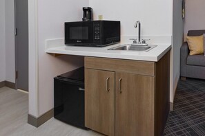 A compact kitchenette with a microwave, sink, and a small refrigerator. - Comfort Suites Springfield-Eugene (Springfield)