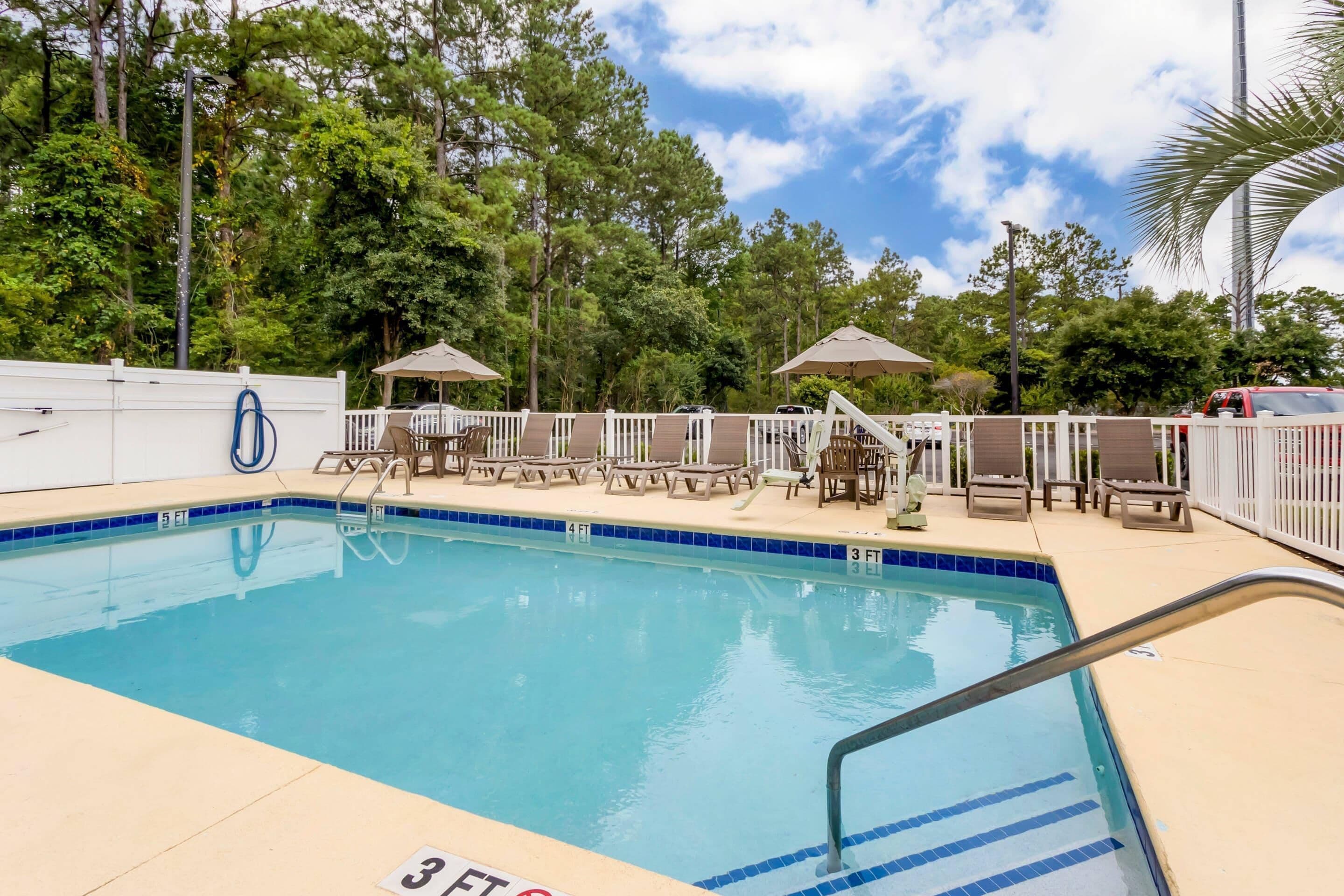Seasonal outdoor pool, open 8 AM to 10 PM, pool umbrellas, pool loungers