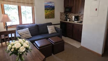 Superior Suite | Living area | 32-inch flat-screen TV with cable channels, TV, DVD player