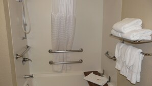 A bathroom with a bathtub, shower, and towel rack. - Comfort Inn Fort Myers Northeast (Fort Myers)