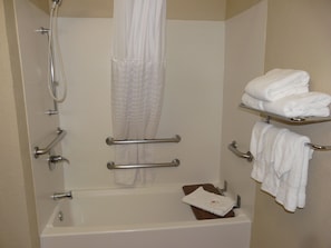 A bathroom with a bathtub, shower, and towel rack. - Comfort Inn Fort Myers Northeast (Fort Myers)