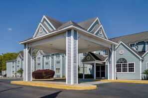 Un hôtel doté d’une entrée abritée, de nombreuses fenêtres et d’une façade symétrique.