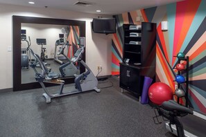 Stay fit and entertained in our well-equipped gym with treadmills, stationary bikes, and a large mirror.