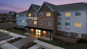 A hotel with a modern design, featuring a mix of brick and siding exteriors, a covered entrance, and a parking area. - TownePlace Suites by Marriott Annapolis (Annapolis)
