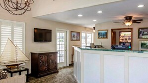 A spacious kitchen with a central island, a chandelier, and a ceiling fan. - Quality Inn Lake George (Lake George)