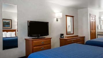 A hotel room with two beds, a television, a dresser, a mirror, and a painting on the wall.