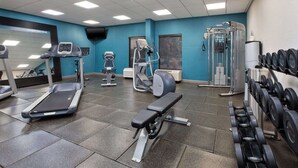 A gym with treadmills, a bench press, and weight machines. - Hampton Inn Cincinnati-Northwest/Fairfield (Fairfield)