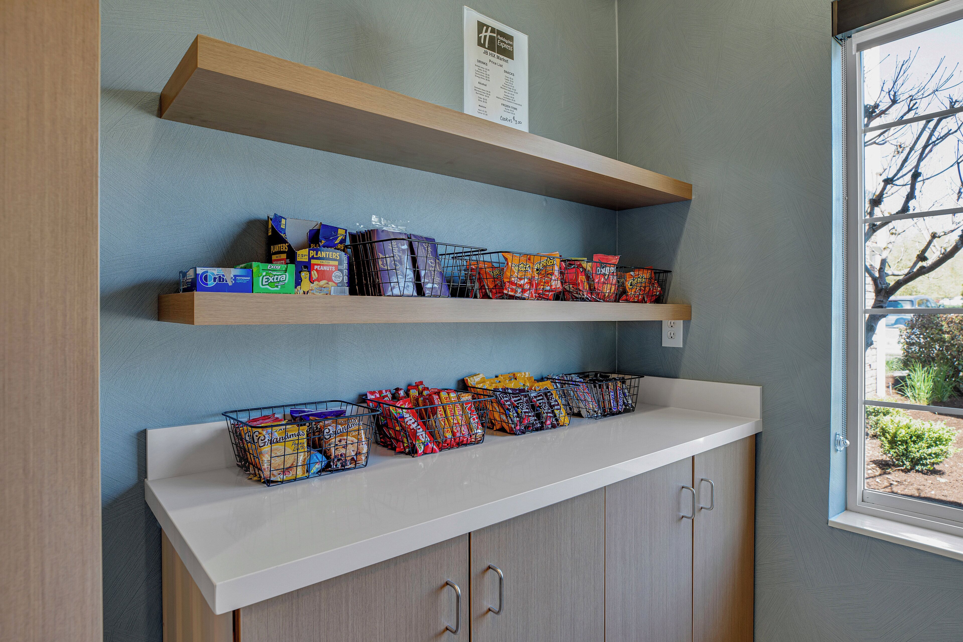 A snack bar with multiple shelves stocked with various packaged snacks.