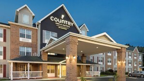 A Country Inn & Suites building with a covered entrance, brick facade, and multiple windows. - Country Inn & Suites by Radisson, Milwaukee Airport, WI (Milwaukee)