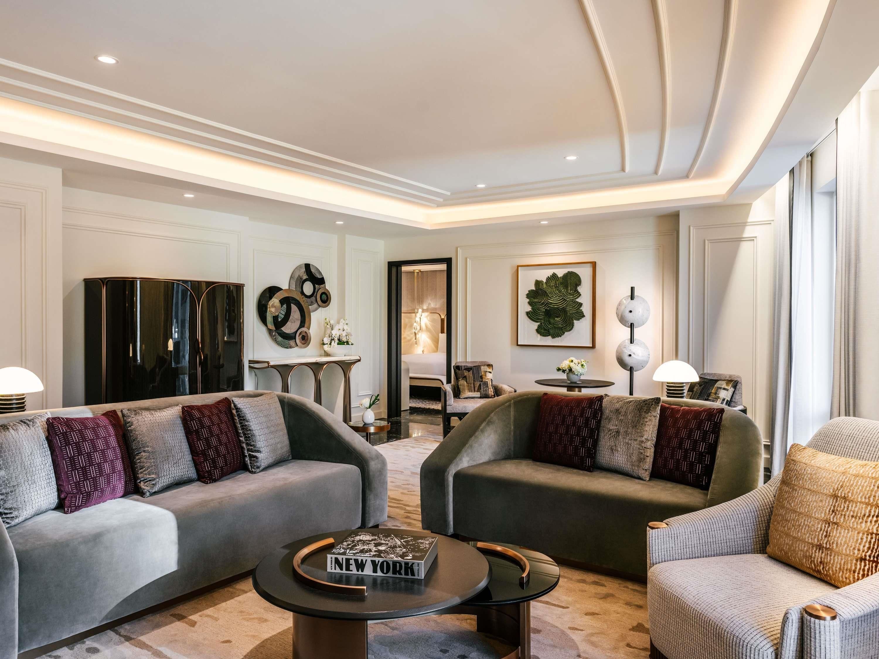A modern living room with two sofas, a coffee table, and a side table.