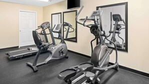 A gym with treadmills, elliptical machines, and a stationary bike. - Best Western Cedar Inn (Cedar Park)