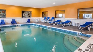 A swimming pool with blue lounge chairs and a tiled deck. - Comfort Suites Fort Wayne North (Fort Wayne)