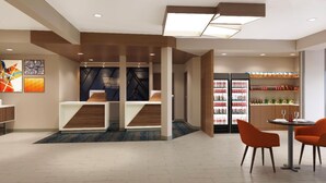 A modern hotel lobby with a seating area, a refreshment bar, and a dining area. - Holiday Inn Express Redding North by IHG (Redding)